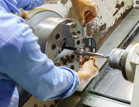 engineer measuring cnc turning part